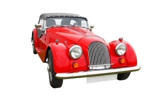 Old vintage red classic convertible car isolated on white background