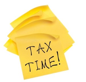 Stack of Blank Yellow Sticky Notes with Edges Curled and Tax Time Message. Isolated on White